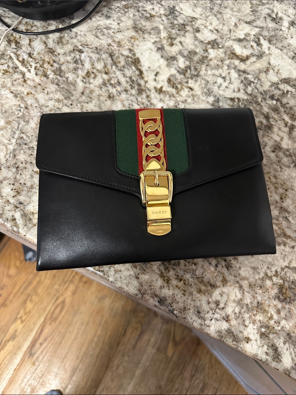 Gucci Black Leather Clutch with Gold and Green Accents PREOWNED.